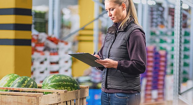 Fruchtgroßhändlerin überprüft im Lager Wassermelonen